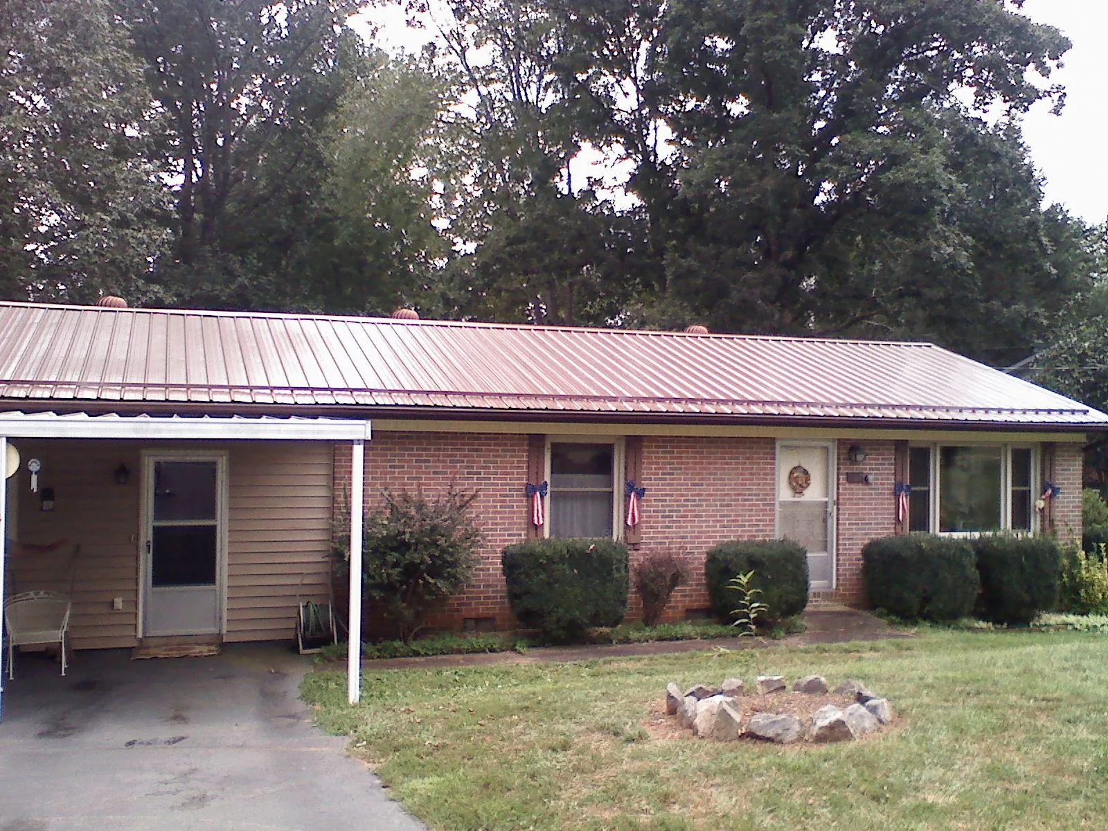 Bronze metal roof and carport on a brick ranch home — Roof Repair work by our crew in South Sutton
