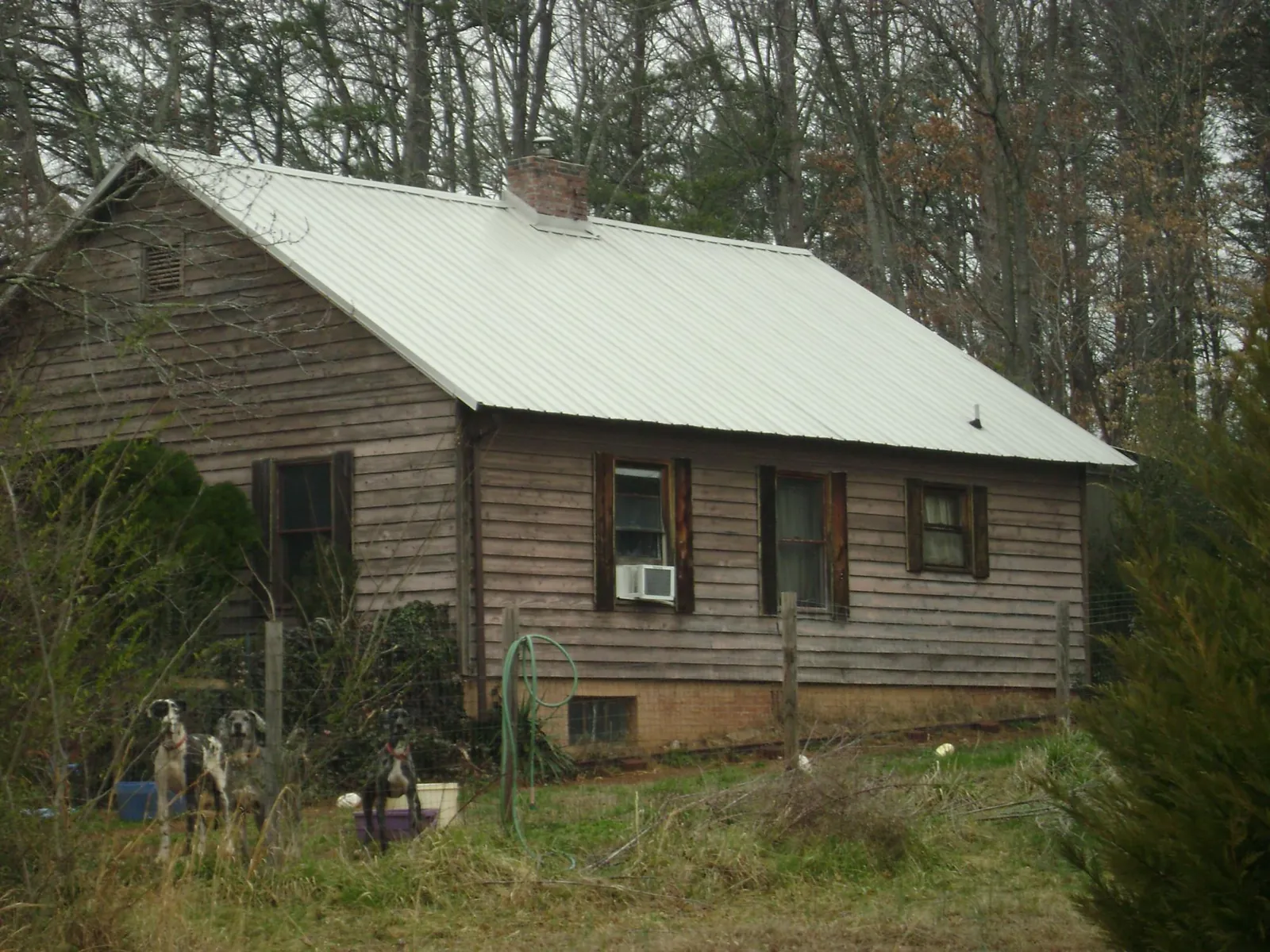 White metal roof on an old wood sided farmhouse, from a Metal Roof Installation job in South Sutton